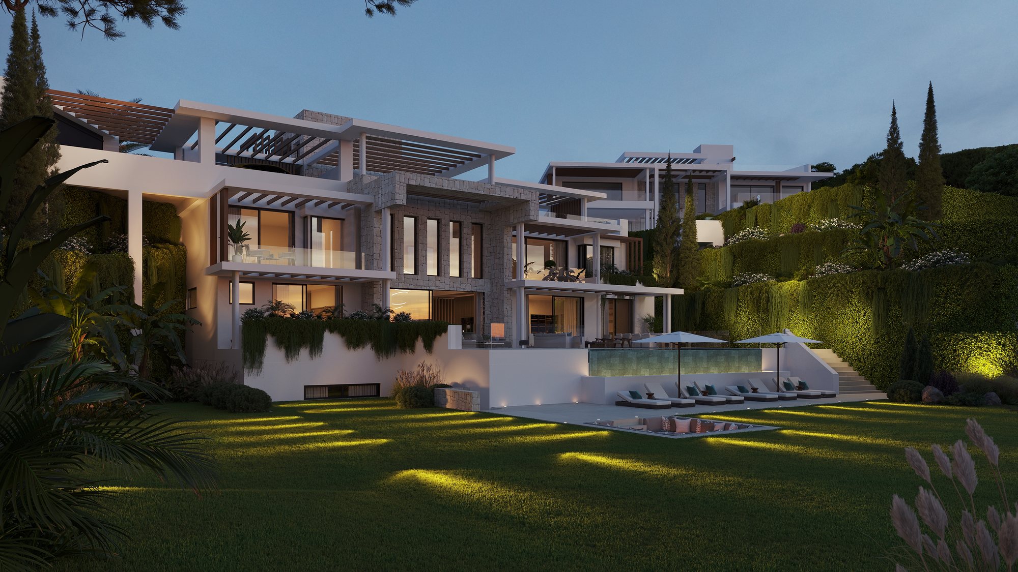 The largest villa at night, the pool and the planting lit from below