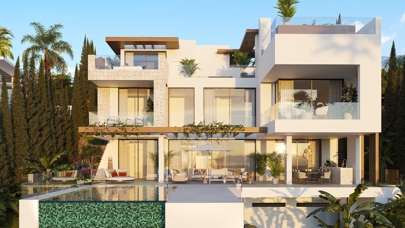 The same villa in the evening, the interiors lit behind full-height glass