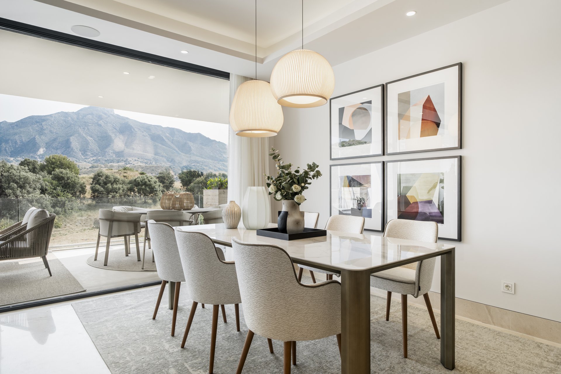 Dining terrace with pendant lighting and mountain views