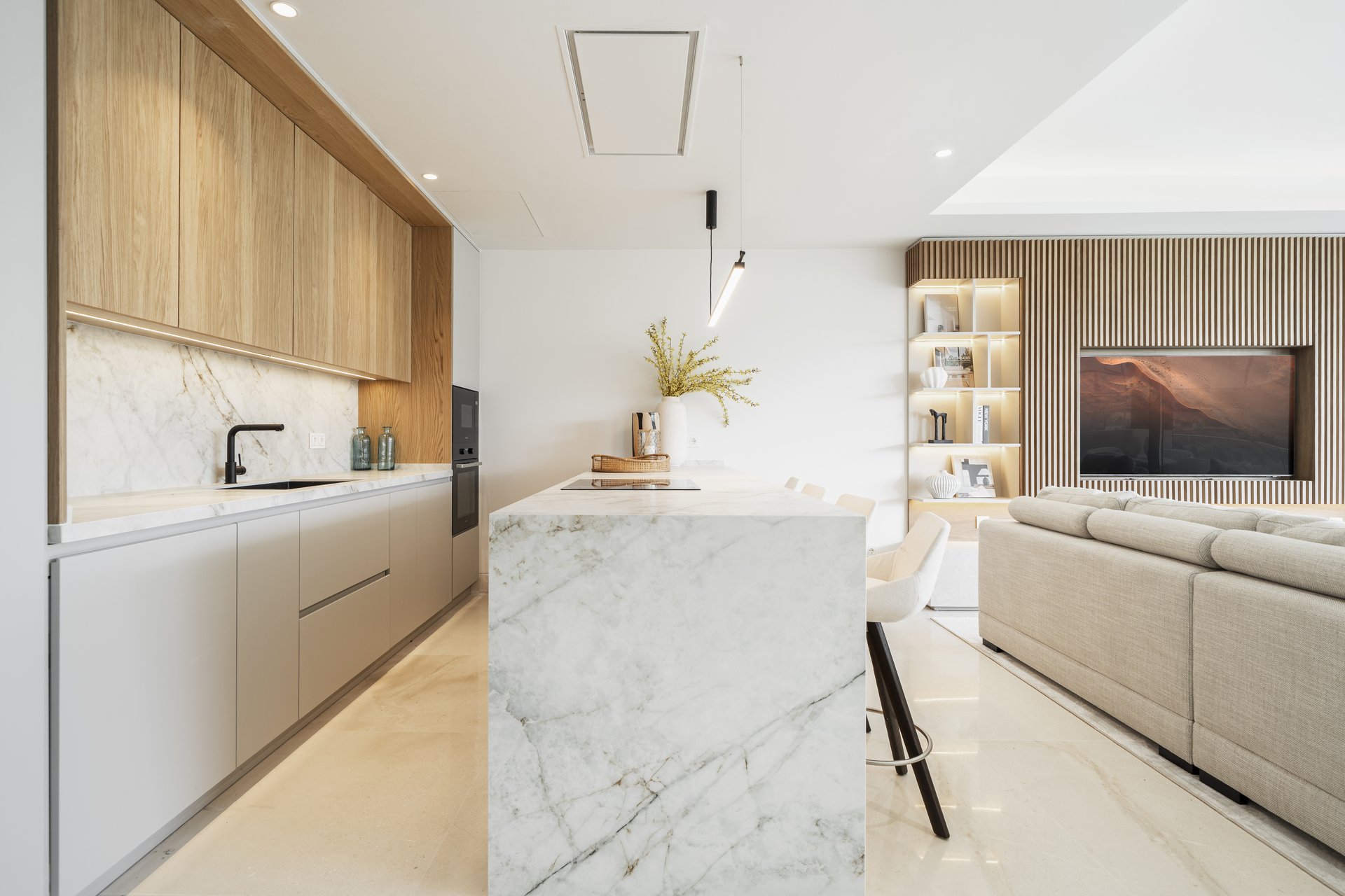 Show apartment kitchen with a marble waterfall island