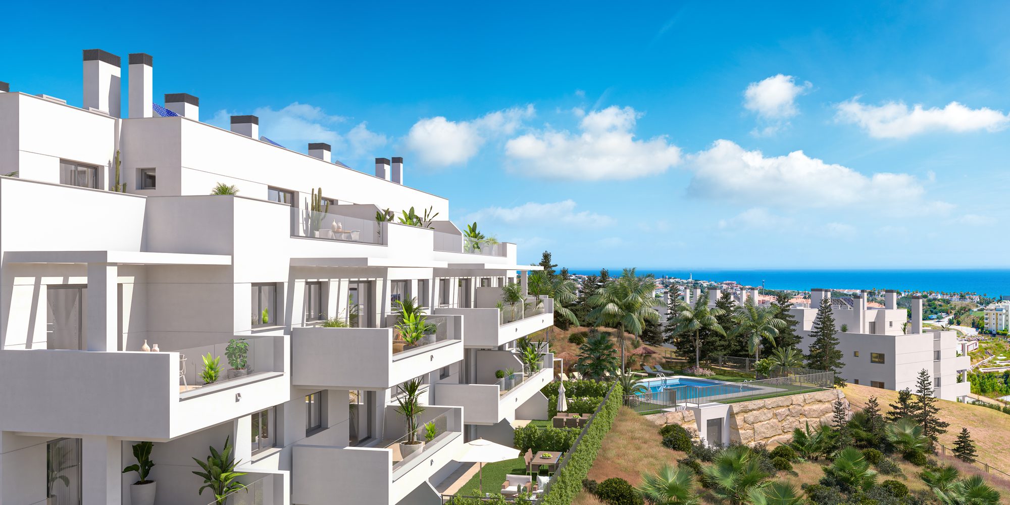 Planted balconies above the pool with the sea beyond