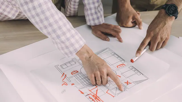Several people comparing details on an architectural floorplan
